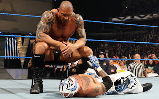 Batista looks down on his battered opponent, Rey Mysterio. 