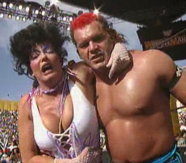 WWE / WWF WRESTLEMANIA 9: Tatanka helps Sensational Sherri to the back following his count-out win over Intercontinental Champion, Shawn Michaels