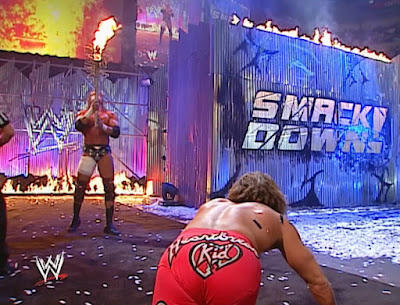 WWE Armageddon 2002 Review - Triple H prepares to hurt Shawn Michaels with a flaming barbwire 2x4