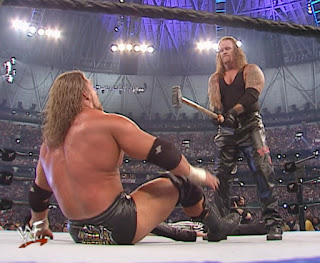 The Undertaker threatens Triple H with a sledgehammer at Wrestlemania 17