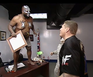 Kamala jumps on William Regal's desk at Wrestlemania.