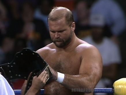 Arn Anderson looks over the NWA world title 